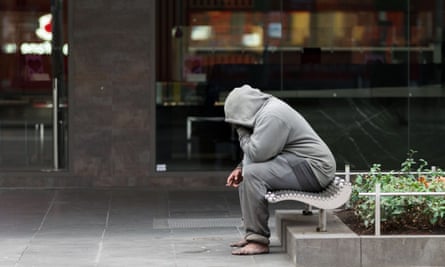A homeless man is seen smoking on Swanston Street in Melbourne, Australia