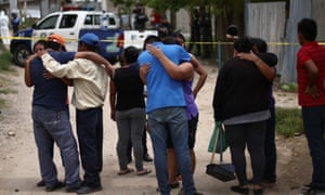Relatives and friends react at a crime scene after a man was killed, in Tegucigalpa, Honduras. Violence in Central American countries is a major driver of migration.