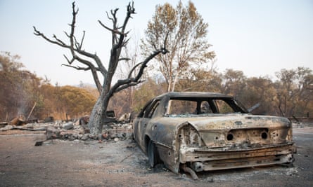 A burned car sits in the driveway of a home just north of Ukiah, California.