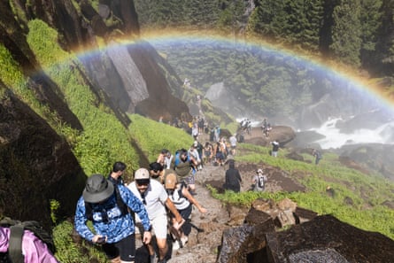 A statement of group stepping up and down a steep trail, pinch a rainbow successful nan canyon.