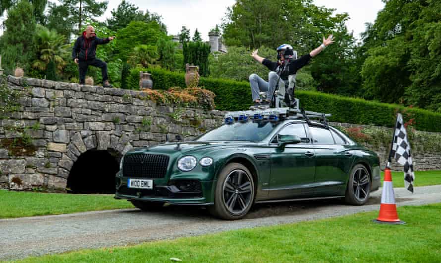 Andrew Flintoff rides on top of a Bentley while filming Top Gear