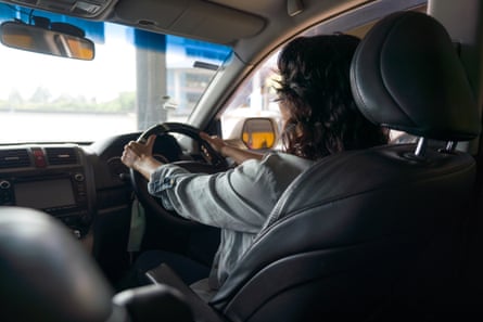 Back view of female driver in vehicle