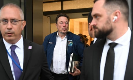 Elon Musk exiting a building