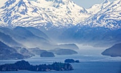 body of water with snowy mountains beyond