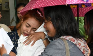 Jiranuch Trirat cradles the body of her 11-month-old daughter at a hospital in Phuket, Thailand.