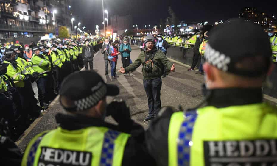 A lone protester is seen surrounded by police officers outside the Cop26 Summit on 3 November.
