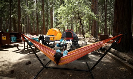 Noah (in hammock) and Valentina Gonzalez from the Sacramento area relax in their campsite in Yosemite national park, California.