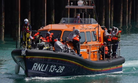 A group of people on an RNLI vessel near Dover, Kent, following a small boat incident in the Channel. 