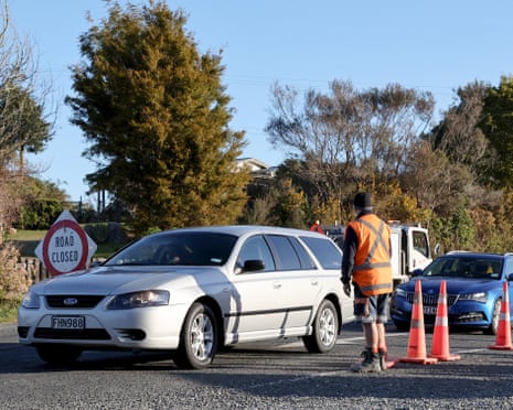 Vehicles drive through a roadblock from the scene of the fatal shooting exchange of fire near the town of Piopio, New Zealand, on Monday