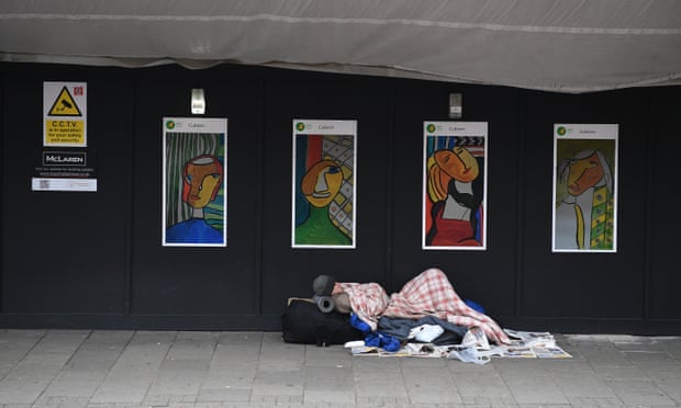 A homeless man sleeps near King’s Cross in London, Britain.