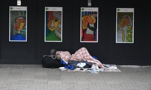 A homeless man sleeps near King’s Cross in London.