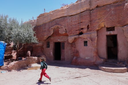 A child running outside doorways into rock