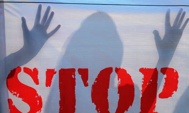 The shadow of an an Indian school student falls on a banner during an awareness campaign to stop child sexual abuse in Hyderabad.
