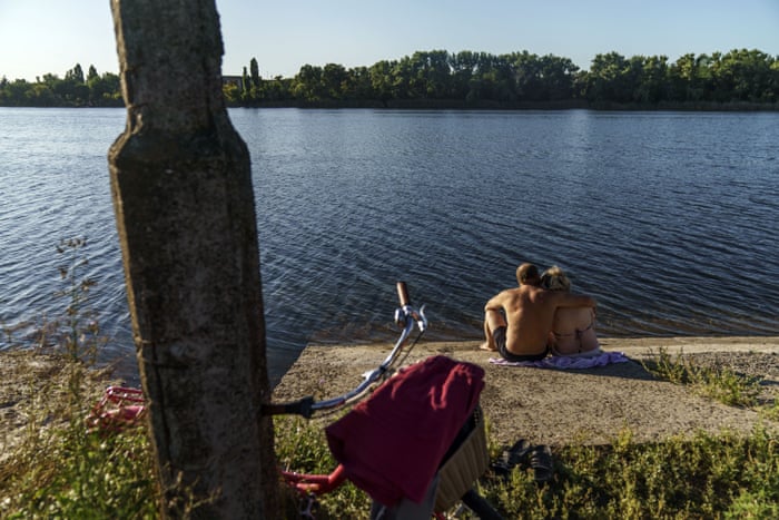 A couple embrace after cooling off in a lake in Sloviansk. While the city’s remaining population has adapted to a new way of life without running water, local officials warn that the coming of winter could set the stage for a humanitarian crisis.
