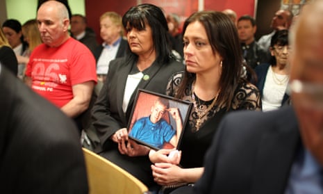 Family members hold photographs of loved ones who died in the Hillsborough disaster ahead of a press conference.
