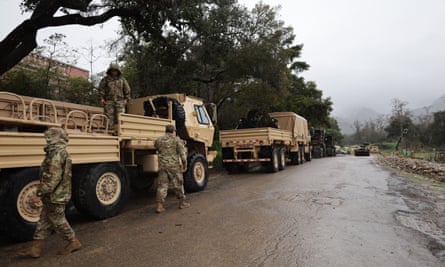 National Guard troops arrive in Montecito to help county officials redirect rain and creek water.