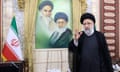 Ebrahim Raisi in front of a portrait of Ayatollahs Ali Khamenei and Ruhollah Khomeini.
