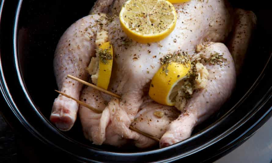 Stuffed chicken, lemon and herbs in a slow cooker.J68FDB Stuffed chicken, lemon and herbs in a slow cooker.