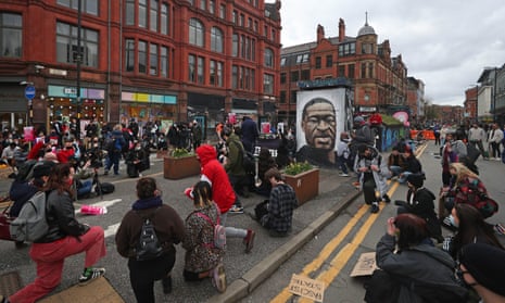Black Lives Matter protesters take a knee during a protest in St Peter’s Square, Manchester, on Saturday