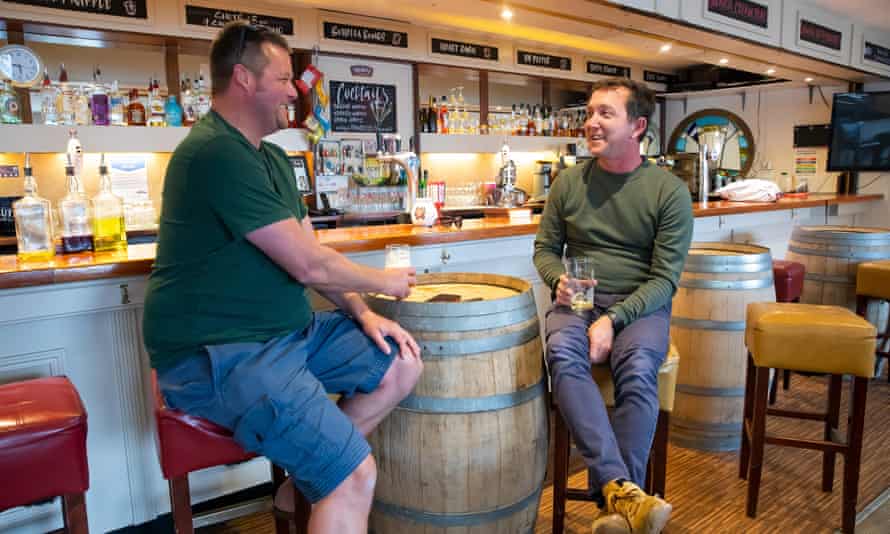 Frazer Cochrane, a local builder, left, and Simon Miller, licensee of the social club, right, in St Mawes in Cornwall.