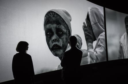 Visitors watch Richard Mosse’s Incoming in the Barbican’s Curve gallery.