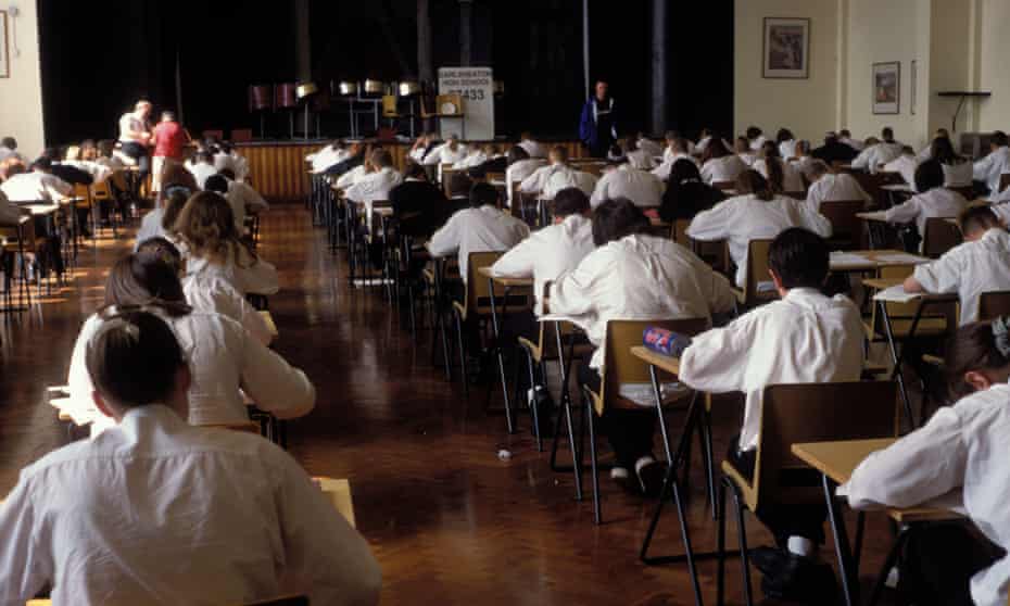 Schools students sit an exam.