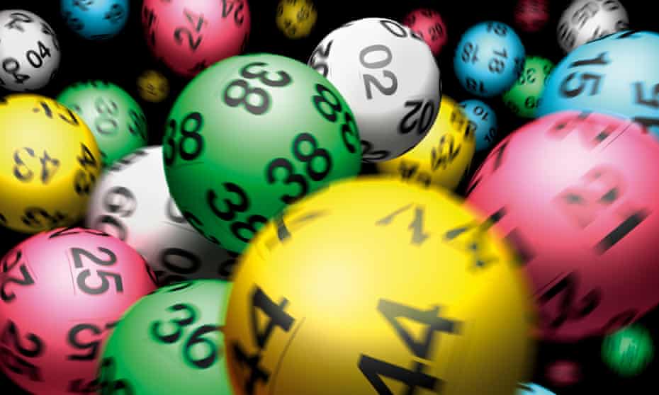 A blurry picture of colourful national lottery balls being agitated