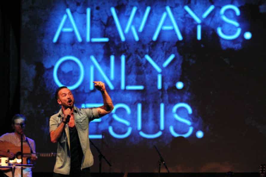 In this July 14, 2013 file photo, Pastor Carl Lentz, foreground, leads a service at Hillsong NYC Church at Irving Plaza in New York City on July 14, 2013