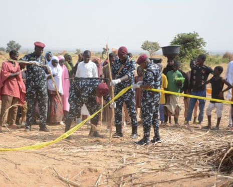 Nigerian police secure the scene of the strike on Friday.