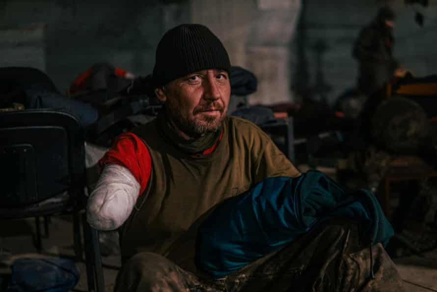 An injured Ukrainian work subordinate sits astatine a tract infirmary wrong a bunker of the Azovstal Iron and Steel Works successful Mariupol, Ukraine.