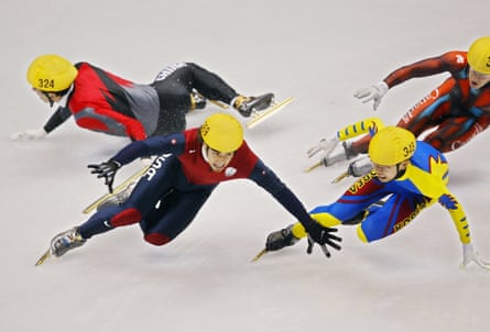 Chinese Jiajun LI (324), US Apolo Anton Ohno (2nd L), South Korean Hyun-Soo Ahn (348), and Canadian Mathieu Turcotte are about to fall during the men’s 1000m final short track race