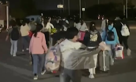 People leaving the Foxconn compound in Zhengzhou on Saturday.