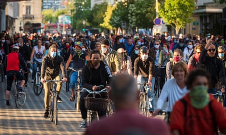 Slovenian citizens wearing protective masks ride their bikes as they block the centre of capital Ljubljana to protest against the centre-right government, accusing it of corruption and of using the pandemic to restrict freedom on May 8, 2020.
