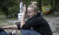 A young woman with her baby reacts emotionally after being evacuated from Vovchansk as she waits to be transferred to a safer location during the Russian military offensive in the Kharkiv region of Ukraine