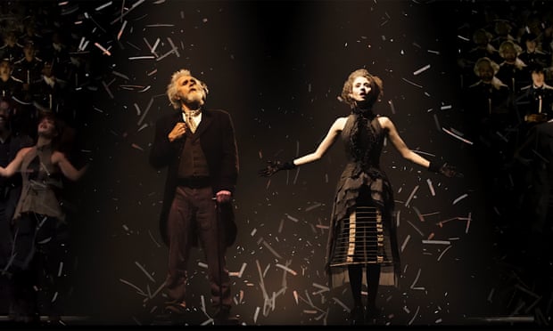 Two actors on stage surrounded by crowds