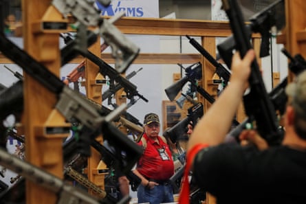 Gun enthusiasts look at rifles during the annual National Rifle Association (NRA) convention in Dallas, Texas.