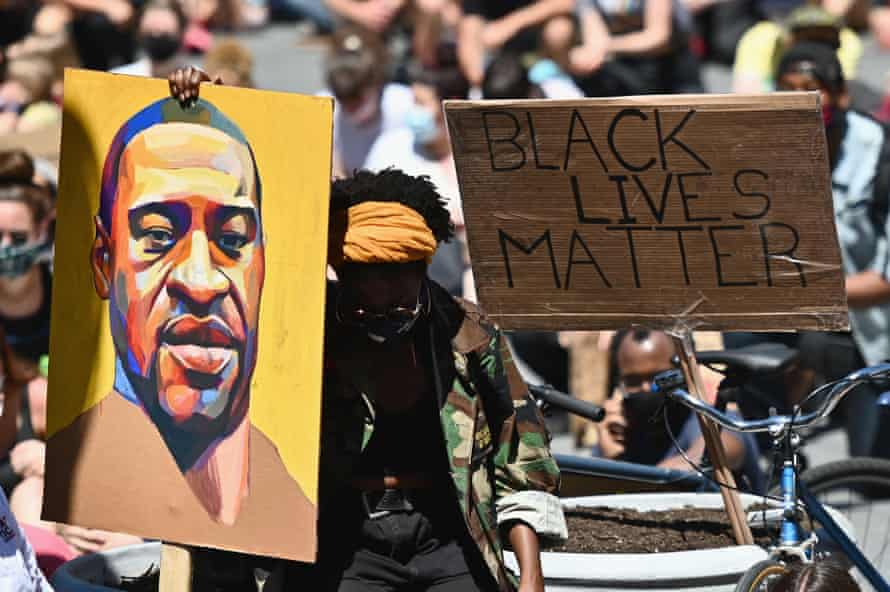 Protesters hold up a portrait of George Floyd at a Black Lives Matter protest in New York, 8 June.