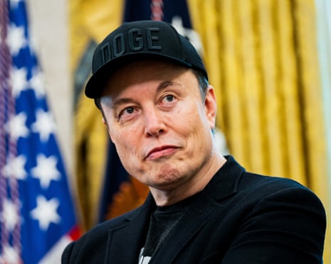 Elon Musk wears a 'Doge' hat during a White House conference.