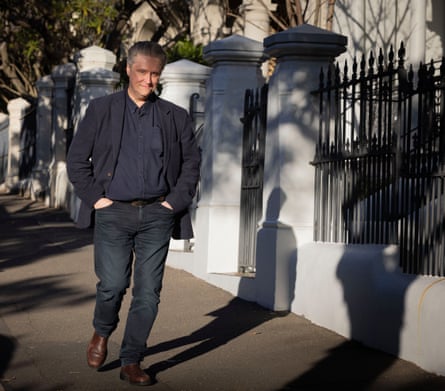 Fidler walks along a street