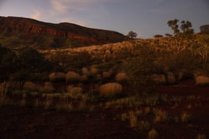 The sun rises over hills