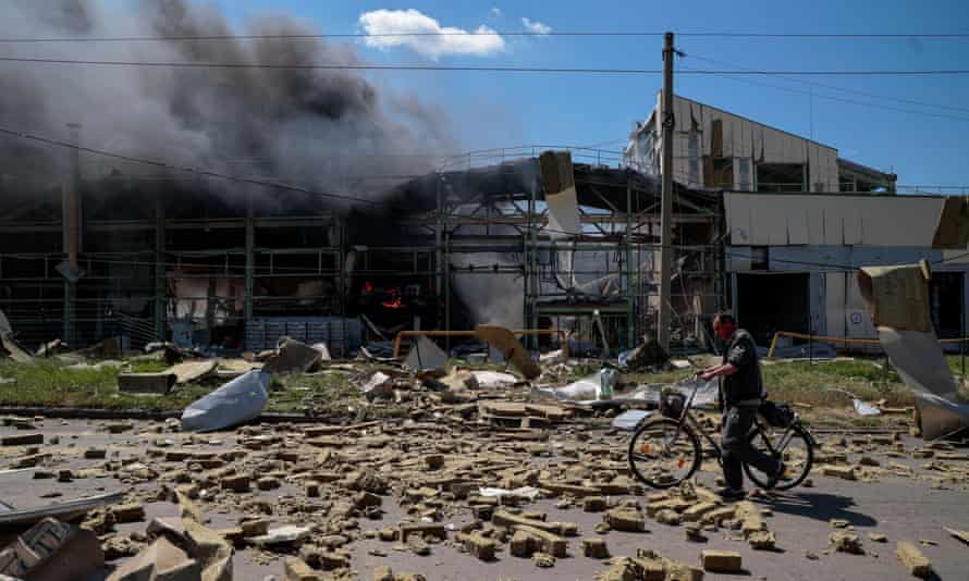 A resident of Bakhmut, a town south-west of Sievierodonetsk, walks past an industrial building damaged by a Russian strike
