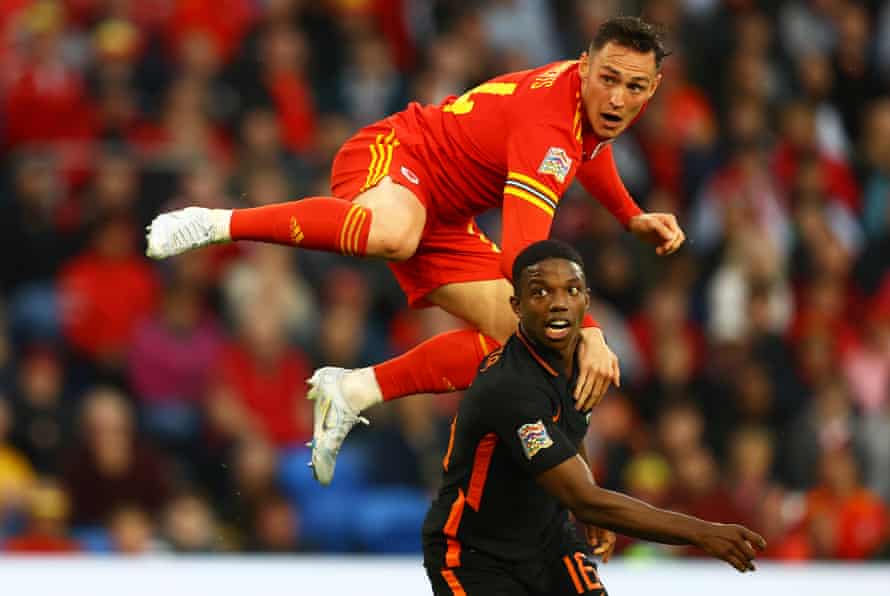 Tyrell Malacia stays grounded as Connor Roberts jumps during this month’s Nations League game between Wales and the Netherlands in Cardiff.
