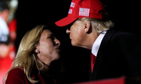 Representative Marjorie Taylor Greene salutes former president Donald Trump during a rally in Commerce, Georgia, on 26 March 2022. 