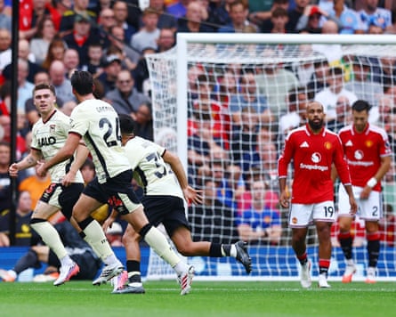 The Ipswich defender Leif Davis celebrates with his teammates after scoring against Manchester United, while United players look on dejectedly.