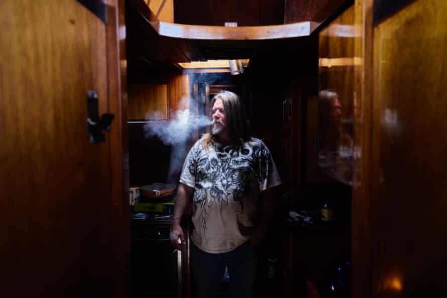 Brian Doris smokes a cigarette on his boat.