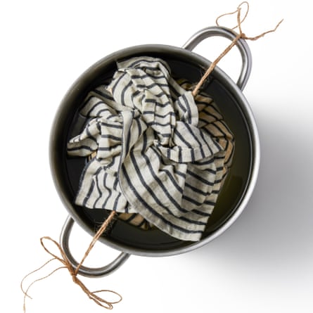 8a Felicity Cloake’s Clootie dumplings... tying the tails of string taut around the handles at each side of a pot