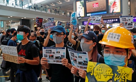Protesters at Hong Kong’s international airport wear eye patches during a mass demonstration in tribute to fellow protester shot in the eye.