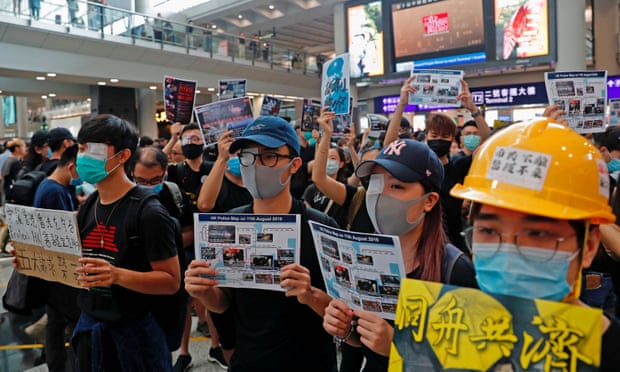 Protesters at Hong Kong’s international airport wear eye patches during a mass demonstration in tribute to fellow protester shot in the eye.