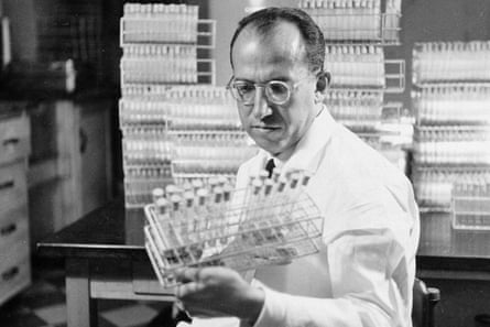 In this Oct. 7, 1954 file photo, Dr. Jonas Salk, developer of the polio vaccine, holds a rack of test tubes in his lab in Pittsburgh, PA