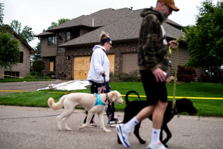 people walking by a house